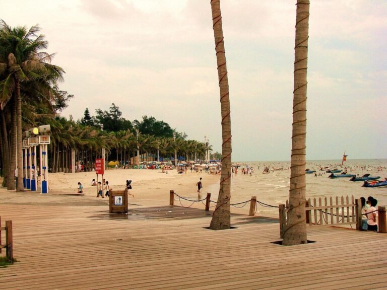 Silver Beach boardwalk in Beihai, Guangxi — palm-lined promenade by the sea